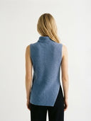 back view of woman wearing a blue sleeveless, turtleneck sweater on a white background #color_dusty-blue