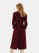 back view of a woman wearing a burgundy long coat on a white background #color_bordeaux