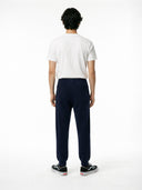 back view of Person wearing a white t-shirt and navy jogger on a white background #color_navy-blazer