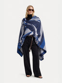 Woman wearing a blue patterned blanket on a white background #color_india-ink