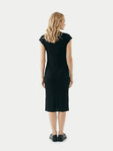 back view of a woman wearing a black dress on a white background #color_all