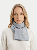 Woman wearing a light gray scarf with a visible brand logo on a white background. #color_light-gray