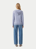 back view of a person wearing a light purple hoodie and blue jeans on a white background. #color_light-gray