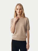 Woman wearing a beige sweater on a white background. #color_beige