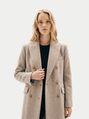front view of a woman wearing a beige coat on a white background. #color_taupe