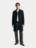 front view of a man wearing a dark coat on a white background. #color_black
