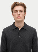 A young man with light brown hair wearing a dark gray heathered knit polo shirt, photographed against a clean light gray background.