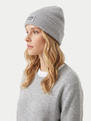 A woman in profile wearing a light gray ribbed knit beanie with a black embroidered 'GOBI' logo on the front, paired with a matching gray crewneck sweater against a light gray background.