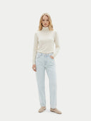 front view of a woman wearing a light-colored sweater and light blue jeans on a white background  #color_white