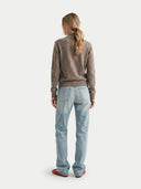 back view of a person wearing a brown sweater and light blue jeans on a white background  #color_taupe