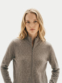 close up front view of a woman wearing a gray zip-up jacket on a light background  #color_taupe