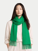 Woman wearing a green scarf on a white background  #color_island-green
