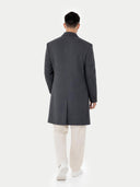 back view of a Person wearing a gray overcoat and white pants on a white background #color_charcoal