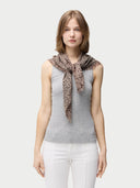 Woman wearing a patterned scarf on a plain background #color_white