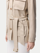 close up of a beige belted jacket with white pants #color_warm-grey