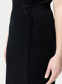 close up of a black dress with a belt and pockets #color_black
