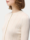 close up of a beige cardigan #color_whisper-white