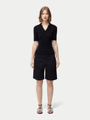 front view of a black polo short with black shorts  #color_black