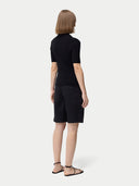 back view of a black polo shirt and pants  #color_black