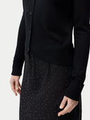 close up of a black cardigan and skirt #color_black