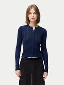 A woman wearing a navy blue button-front cashmere silk cardigan with a crew neckline. #color_mood-indigo