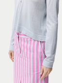 close up of a light blue long sleeve top with buttons and pink pants #color_ice-flow