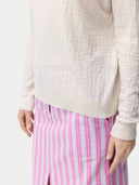 close up of a white sweater and pink pants #color_whisper-white