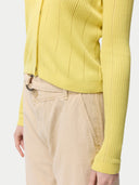 close up of yellow cardigan with beige pants #color_blazzing-yellow