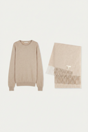 A light beige crewneck sweater and a matching fringed scarf laid flat on a clean white background.