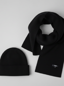 Black beanie and scarf set on a light gray background  #color_black