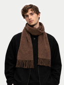 Man wearing a brown scarf on a plain background