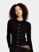 Woman wearing a black cardigan with a plain background #color_black