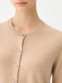 Close-up of a beige cardigan with buttons on a plain background #color_beige
