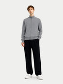 front view of a man wearing a gray zip-up sweater and black pants on a white background  #color_dim-gray