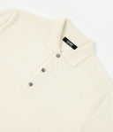 Cream-colored polo shirt with a brand label on a white background