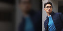 A man in glasses and a navy CashmereTech quilted jacket over a blue cashmere sweater