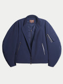 Flat lay of the CashmereTech bomber jacket in crown blue, opened to show the quilted inner jacket layered inside.