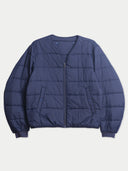 Flat lay of the collarless quilted inner jacket of the CashmereTech bomber in crown blue, with a full-length zip and ribbed cuffs.