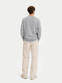 back view of a Person wearing a gray sweater and beige pants on a white background #color_vapor-blue