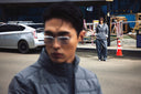 A man in a grey CashmereTech puffer jacket on a city street