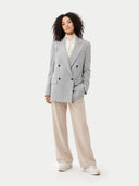 front view of Woman wearing a gray blazer and beige pants on a white background #color_vapor-blue