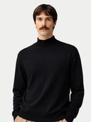 Man wearing a black turtleneck sweater against a plain background #color_black