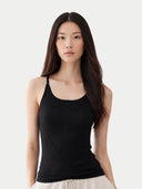 Woman wearing a black tank top against a white background #color_black