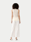 back view of Woman wearing a sleeveless top and wide-leg pants on a white background #color_marshmallow