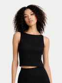 Woman wearing a black sleeveless top against a plain background #color_black