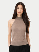Woman wearing a beige sleeveless top against a white background #color_taupe