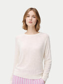 close up front view of a woman wearing a light pink sweater and pink striped pants on a white background #color_whisper-white