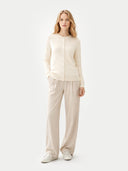 Woman wearing a beige outfit on a white background  #color_off-white