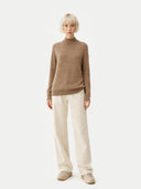 front view of a Person wearing a brown sweater and white pants on a white background #color_taupe