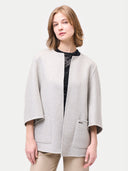 Woman wearing a light gray coat with a black lace trim on a white background #color_dawn-blue